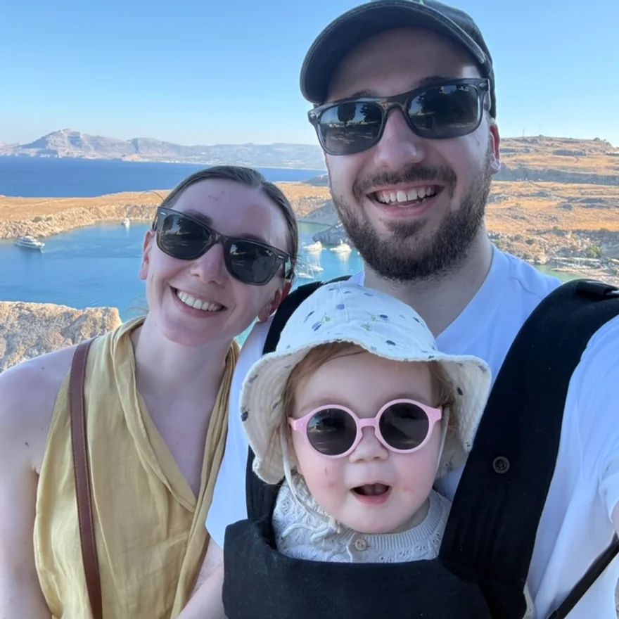 Max, his partner and Eva above a bay in Greece